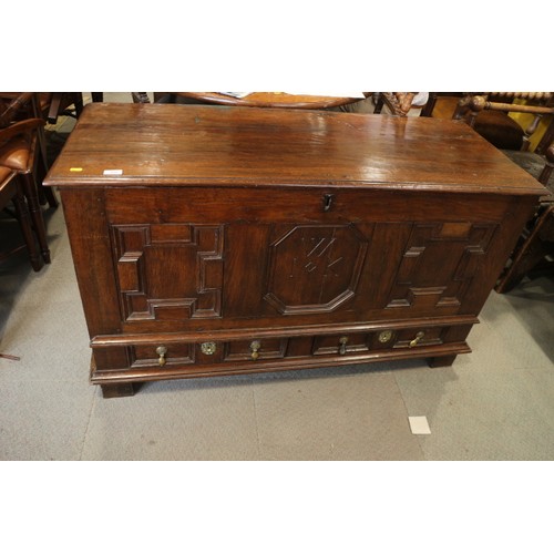 439 - An 18th century  oak triple fielded panel front  chest, monogram WIK, on stile supports, 50