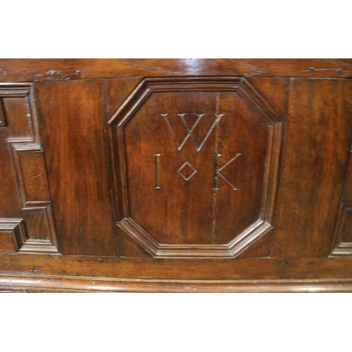 439 - An 18th century  oak triple fielded panel front  chest, monogram WIK, on stile supports, 50