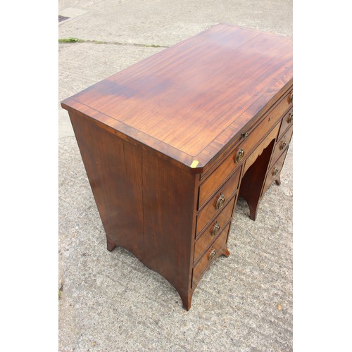 448 - A George III figured mahogany, ebony line inlaid and banded knee hole desk, fitted adjustable writin... 