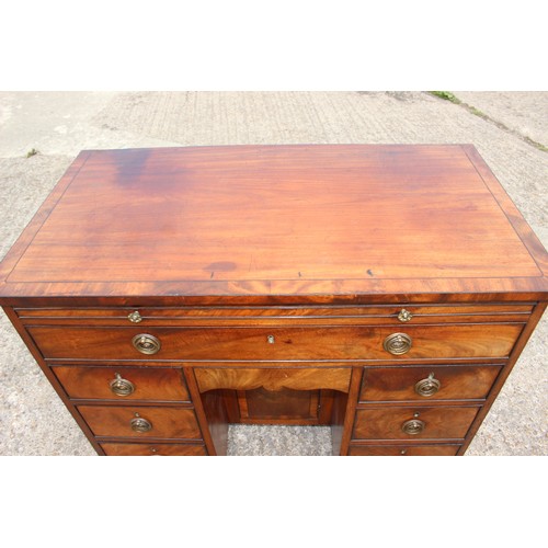 448 - A George III figured mahogany, ebony line inlaid and banded knee hole desk, fitted adjustable writin... 