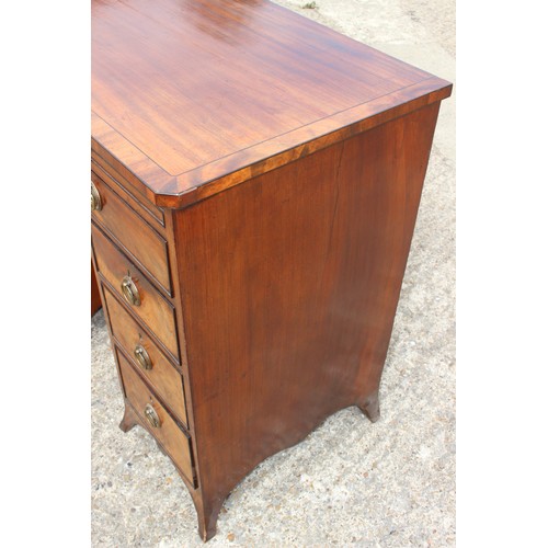 448 - A George III figured mahogany, ebony line inlaid and banded knee hole desk, fitted adjustable writin... 