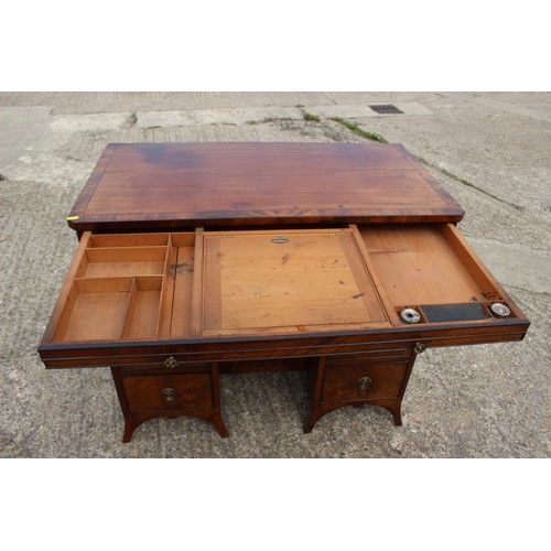 448 - A George III figured mahogany, ebony line inlaid and banded knee hole desk, fitted adjustable writin... 