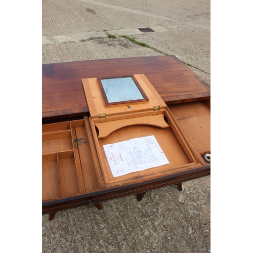 448 - A George III figured mahogany, ebony line inlaid and banded knee hole desk, fitted adjustable writin... 