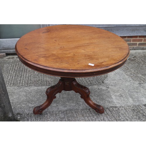 445 - A 19th century circular tilt top dining table, on carved column and tripod splay castored support, 4... 