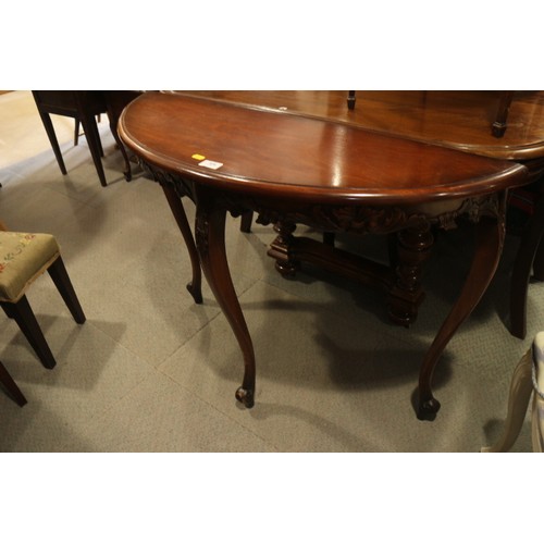 526 - A carved and polished as walnut semicircular side table, 36