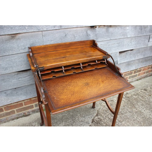 539 - A walnut metamorphic side/writing table, the interior with tooled leather writing surface and pigeon... 