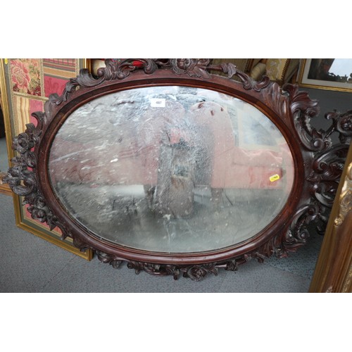 487 - A carved hardwood framed oval wall mirror, 44