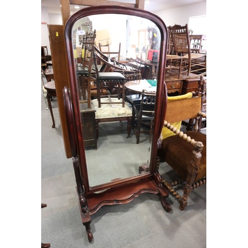 488 - A carved hardwood framed cheval mirror with arch top plate, on plateau base and scroll feet, 30