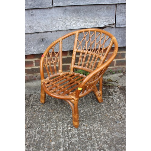 593 - A child's bentwood cantilever elbow chair and a child's rattan low seat armchair