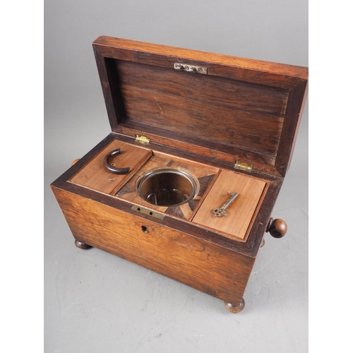 142 - A 19th century rosewood sarcophagus tea caddy,  with ring handles, on bun feet, 14 1/4