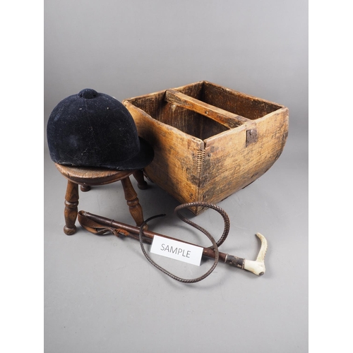 183 - An oak square-shaped and metal mounted bucket, two riding crops, a riding helmet, a 19th century sto... 