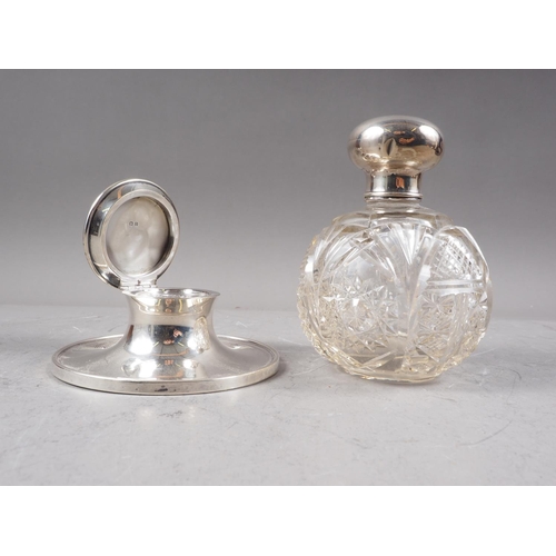 306 - A cut glass scent bomb with silver lid and a silver capstan inkwell