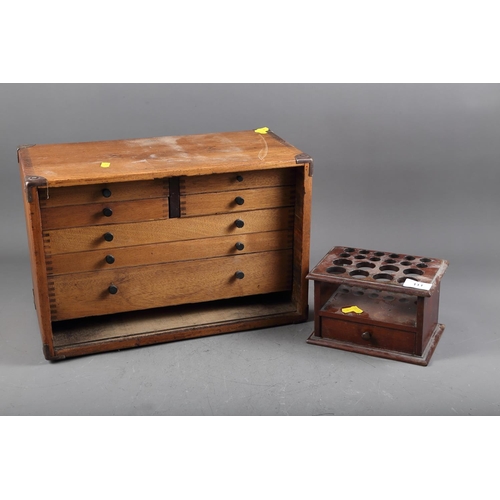 111 - A mahogany storage chest with four short and three long graduated drawers, containing various scient... 