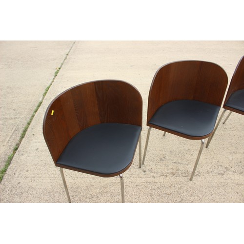 611 - A set of four chrome framed bentwood chairs with black vinyl seats