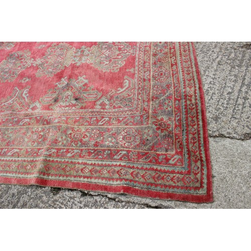 624 - A vintage Turkey carpet of traditional design on a red ground, 166” x 139” approx