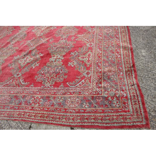 624 - A vintage Turkey carpet of traditional design on a red ground, 166” x 139” approx