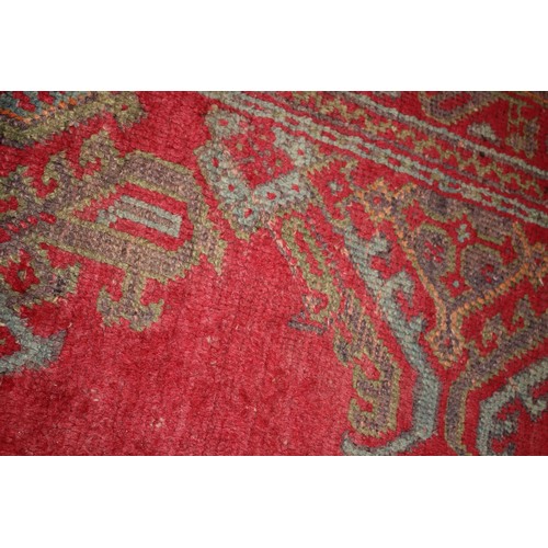 624 - A vintage Turkey carpet of traditional design on a red ground, 166” x 139” approx