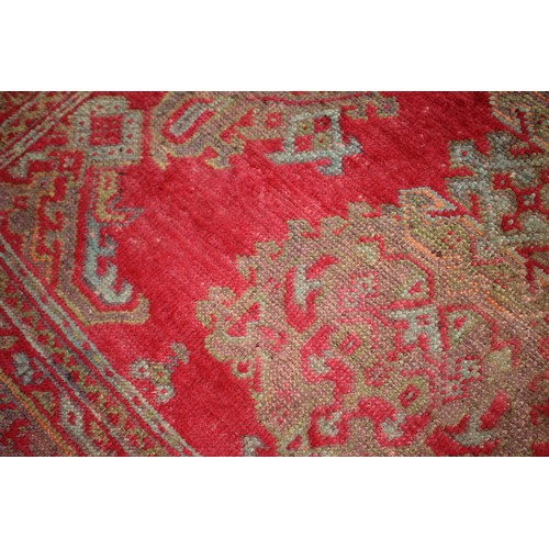 624 - A vintage Turkey carpet of traditional design on a red ground, 166” x 139” approx