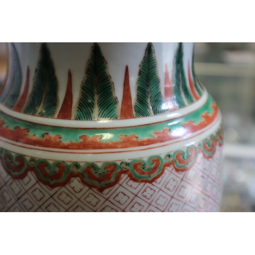 75 - A Chinese famille verte vase with panels of figures in a landscape decoration, 18 1/2