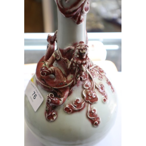 76 - A Chinese pale glazed bottle neck vase with relief iron oxide coloured dragon decoration, 11 3/4