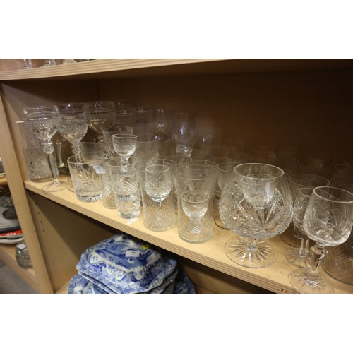 52 - A cut glass part table service, and a quantity of champagne flutes, coupes and other glassware