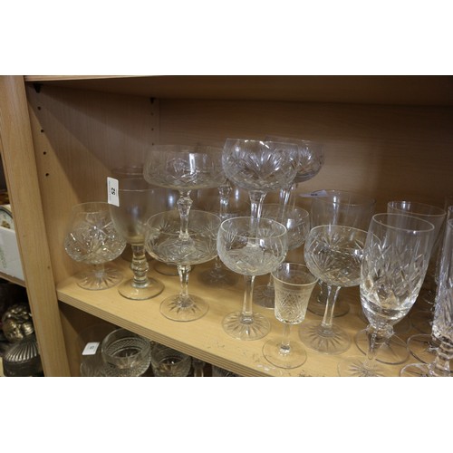 52 - A cut glass part table service, and a quantity of champagne flutes, coupes and other glassware