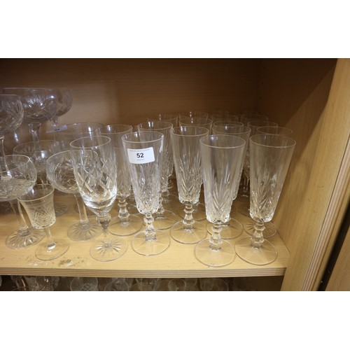 52 - A cut glass part table service, and a quantity of champagne flutes, coupes and other glassware