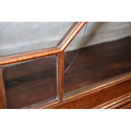 464 - A Georgian mahogany bureau bookcase, the upper section dentil moulding, enclosed glazed panel doors ... 