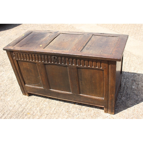 558 - An 18th century oak triple panel front coffer, on stile supports, 44