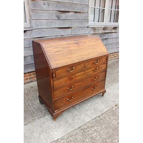 564 - A Georgian mahogany fall front bureau, the interior fitted drawers and pigeonholes over two short an... 