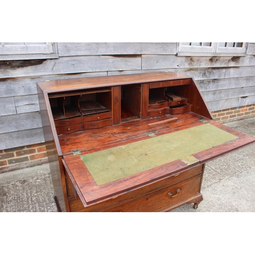 564 - A Georgian mahogany fall front bureau, the interior fitted drawers and pigeonholes over two short an... 