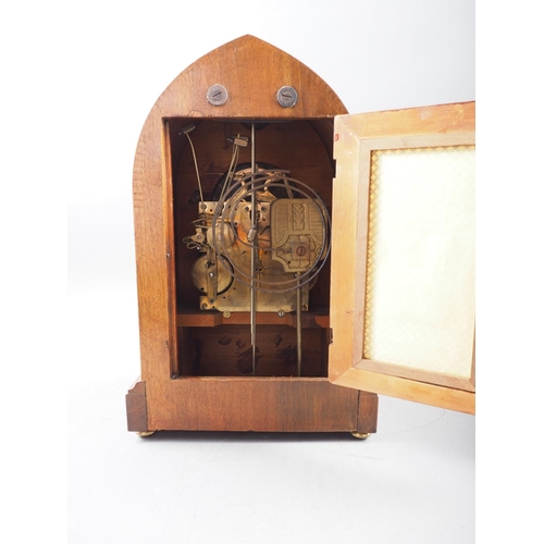 114 - An Edwardian mahogany and line inlaid arch topped mantel clock with silvered dial and Roman numerals... 