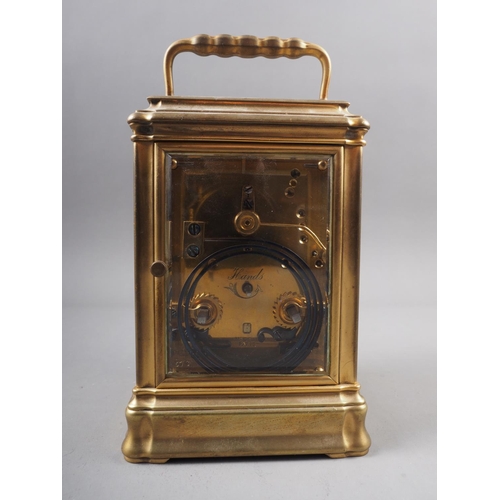 130 - A French gilt and brass repeating carriage clock with bevelled glass, white enamelled dial and Roman... 