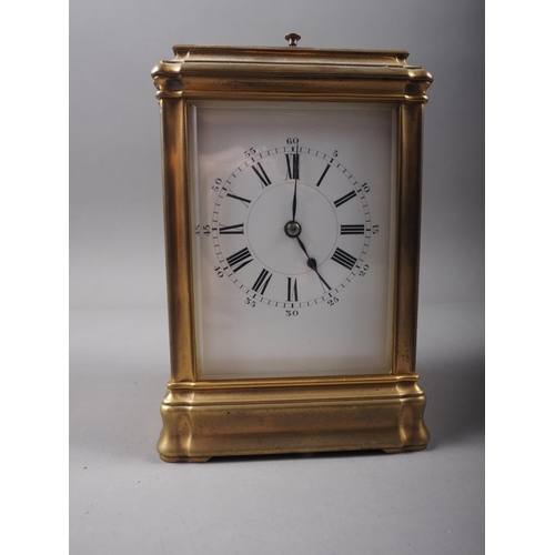 130 - A French gilt and brass repeating carriage clock with bevelled glass, white enamelled dial and Roman... 