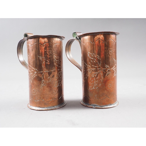 141 - A pair of Newlyn copper mugs, decorated leaves and flowers, 4 1/2