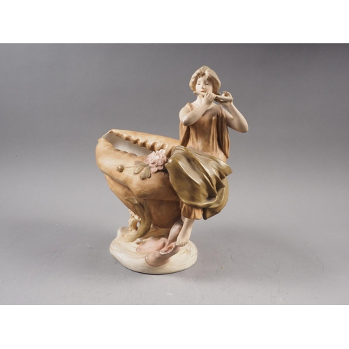 18 - A Royal Crown Dux table centre, formed as a girl playing a flute seated on a shell, 10 1/2