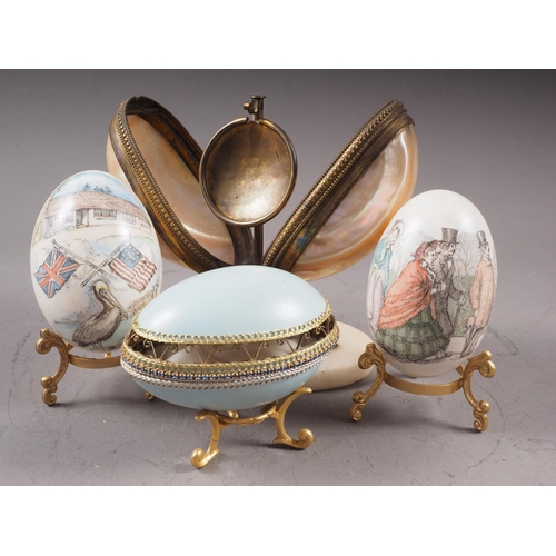 248 - A French mother-of-pearl and brass mounted egg-shaped pocket watch stand, on oval stone base, 5 1/2