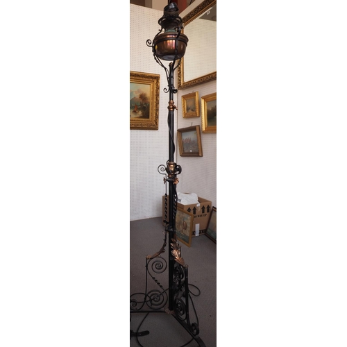 267 - An early 20th century wrought iron and copper adjustable oil lamp, on tripod scroll support (now con... 