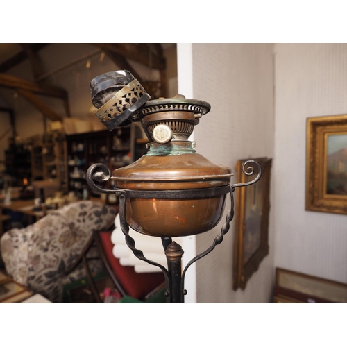 267 - An early 20th century wrought iron and copper adjustable oil lamp, on tripod scroll support (now con... 