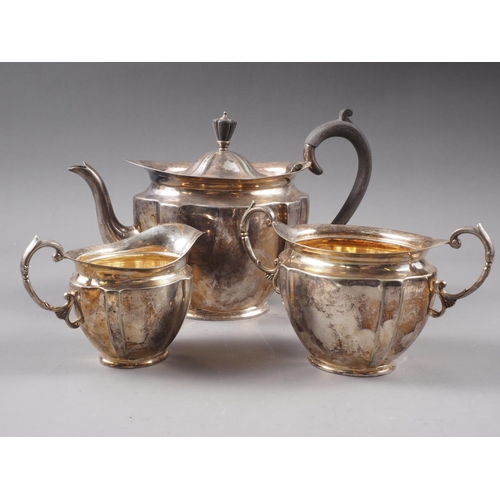 295 - A plated three-piece teaset, oval silver photo frames, and one other silver photo frame