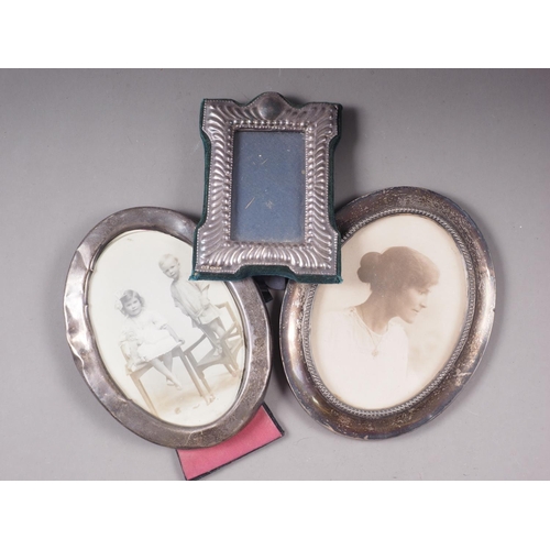 295 - A plated three-piece teaset, oval silver photo frames, and one other silver photo frame