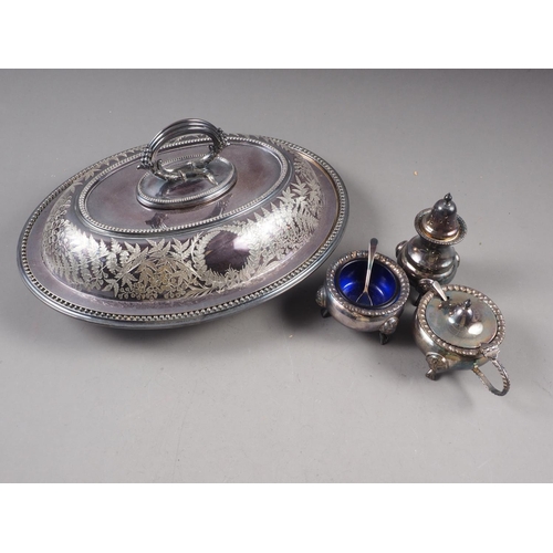 297 - A silver plated entree dish and cover with engraved leaf decoration, and a plated three-piece cruet ... 