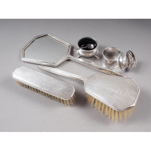 322 - A three-piece silver backed dressing table set, two silver napkin rings, a salt cellar and a salt sp... 