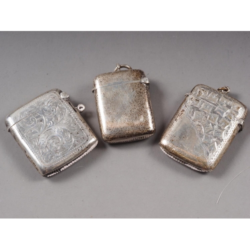 325 - Two silver vesta cases with engraved decoration, and another similar vesta case, 2oz troy approx