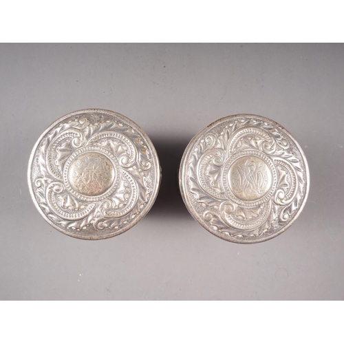 326 - A pair of Americ`an white metal dressing table boxes and covers with engraved and embossed decoratio... 