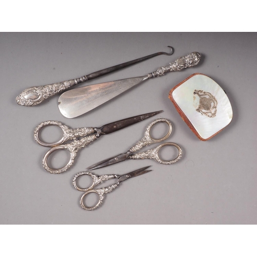 329 - A silver handled button hook, three similar pairs of scissors, a shoe horn and a mother-of-pearl and... 