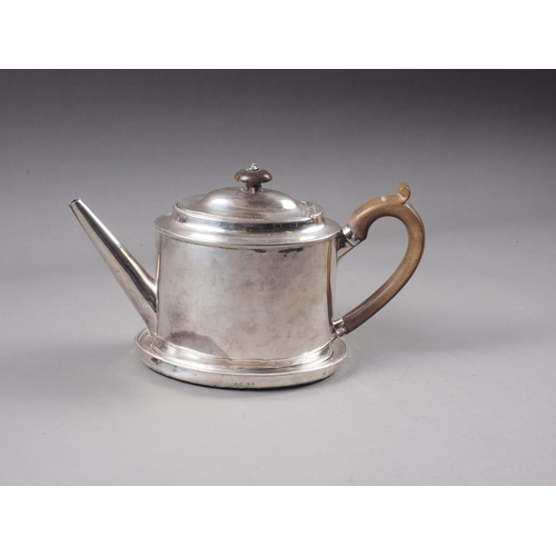 332 - A Georgian silver oval shaped teapot of plain design with hardwood handle and knop, and a matched si... 