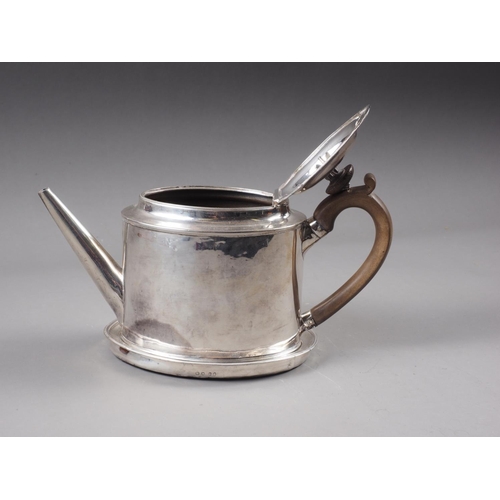 332 - A Georgian silver oval shaped teapot of plain design with hardwood handle and knop, and a matched si... 