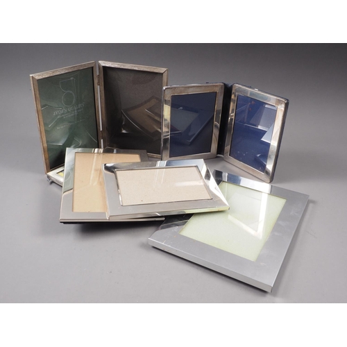 333 - A silver hinged double photograph frame, a rectangular silver photograph frame and four silver plate... 