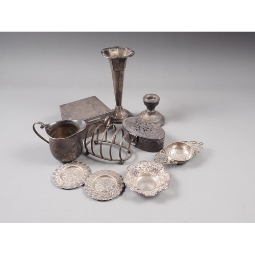 337 - A silver milk jug, a silver toast rack, a silver tea strainer, a silver bonbon dish, a silver trumpe... 